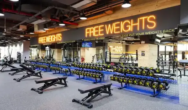 Gym free weight room equipped with dumbbells, barbells, and many more weightlifting equipments.
