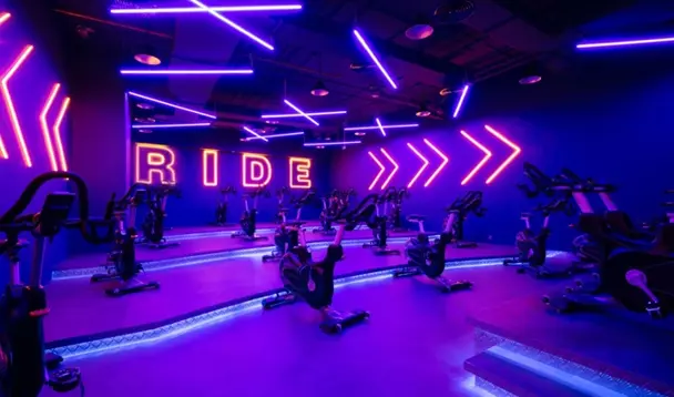 Gym spinning room equipped with stationary bikes for cycling workouts and fitness classes.